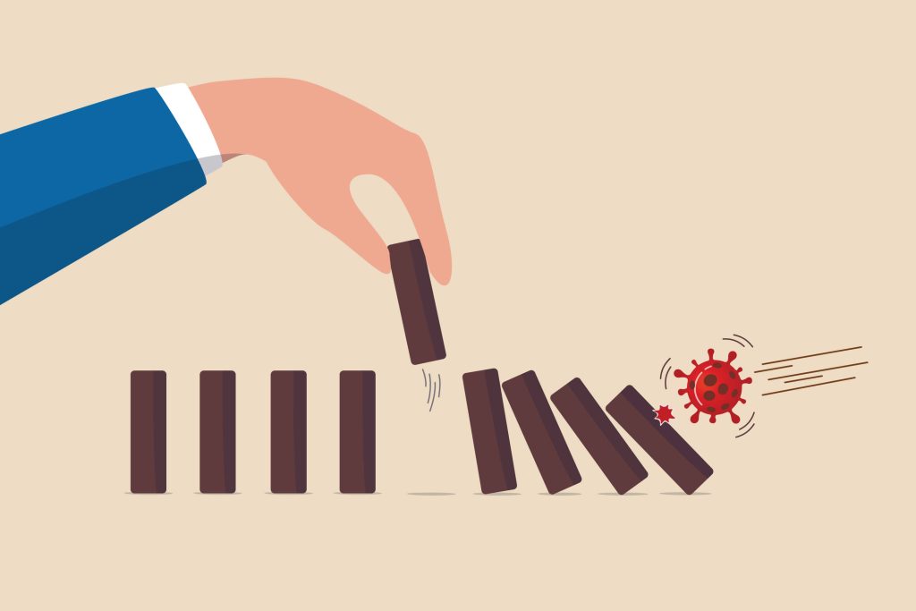 Dominoes falling as coronavirus particles knock them over.